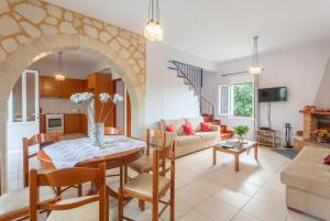 a kitchen and living room with a table and chairs at Villa Giannis in Áyios Andónios