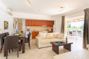 a living room and kitchen with a couch and a table at Villa Cherry in Plateies
