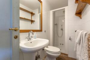a bathroom with a sink and a toilet and a shower at Villa Il Giulione Large Private Pool WiFi in Trevinano +36 photos