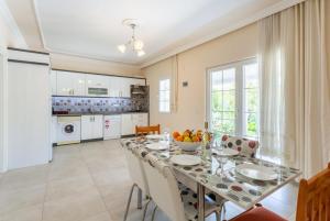 a kitchen and dining room with a table and chairs at Villa Duman 3 in Dalyan