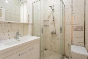 a bathroom with a shower and a sink and a toilet at Villa Duman 3 in Dalyan +12 photos