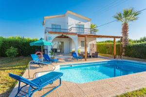 a villa with a swimming pool in front of a house at Argaka Sun Villa Ena in Argaka