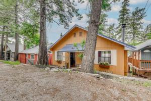 a house with trees in front of it at Charming Cloudcroft Retreat with Fire Pit! in Cloudcroft