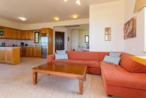 a living room with a couch and a coffee table at Villa Selini in Roussospítion