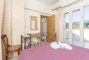 Postel nebo postele na pokoji v ubytování Villa Ismini