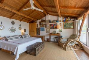 a bedroom with a bed and a chair in it at The Olive Press - Agni Bay in Agní