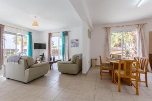 a living room with a couch and a table and chairs at Villa Aspelia in Neo Chorio