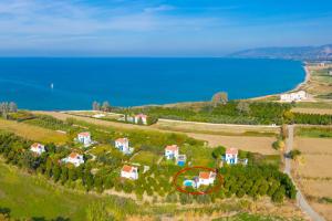 an aerial view of a house on a hill next to the water at Sun Beach Villa in Polis Chrysochous