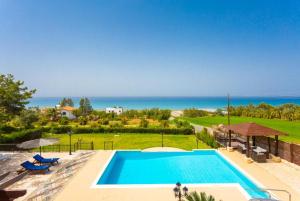 a swimming pool with a view of the ocean at Villa Minoas in Argaka