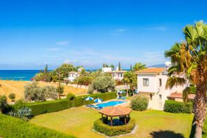 an aerial view of a villa with a swimming pool and the ocean at Villa Halima Georgios in Polis Chrysochous
