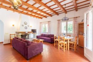 a living room with a couch and a table at Villa Trepuco Dos in Punta Prima
