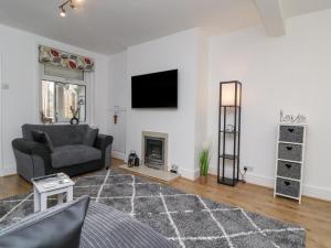 a living room with a couch and a fireplace at 3 Glendowne Terrace in Harrogate