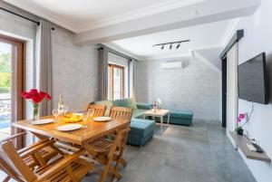 a dining room and living room with a wooden table at Villa Asli Paradise in Mugla