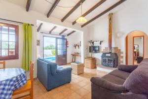 a living room with a couch and a fireplace at Villa Ca Nostra in Cala'n Porter