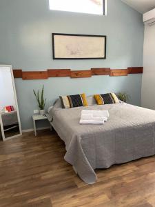 a bedroom with a bed with two towels on it at Spacious modern apartment in Noord