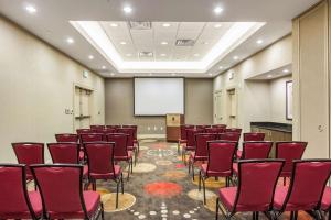 a conference room with red chairs and a screen at Embassy Suites by Hilton Newark Airport in Elizabeth +29 photos