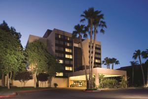 a building with palm trees in front of it at DoubleTree by Hilton Fresno Convention Center in Fresno