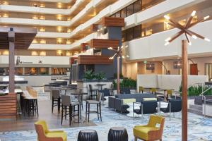 a lobby of a hotel with tables and chairs at DoubleTree by Hilton Fresno Convention Center in Fresno