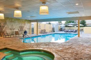 a large swimming pool in a hotel lobby at DoubleTree by Hilton Fresno Convention Center in Fresno