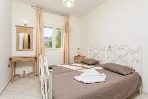 een slaapkamer met 2 bedden en een spiegel bij Villa Fedra in Póros