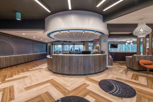 a lobby with a reception desk and a large chandelier at Tru by Hilton Fayetteville I-95 in Fayetteville