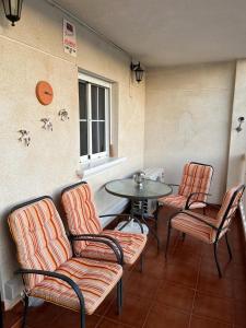 a room with a table and two chairs and a table and a table and chairs at Casa de Don Simón in Cabo Roig
