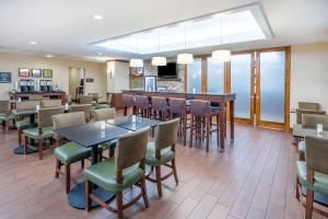 a restaurant with tables and chairs and a bar at Hampton Inn Frostburg in Frostburg