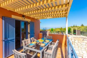 a patio with a table and chairs on a deck at Villa Canova in Mesovoúnia