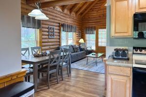 a kitchen and living room with a table and chairs at Reindeer Hideaway in Pigeon Forge