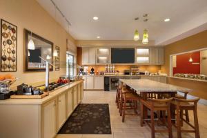 a kitchen with a table and a dining room at Hilton Garden Inn Flagstaff in Flagstaff