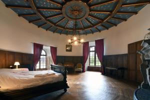 a bedroom with a bed with a large ceiling at Château de Bellignies in Bellignies