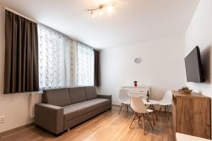 a living room with a couch and a table at Apartmán Janka in Liptovský Ján