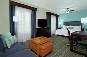 a hotel room with a bed and a desk at Homewood Suites by Hilton Fort Lauderdale Airport-Cruise Port in Dania Beach