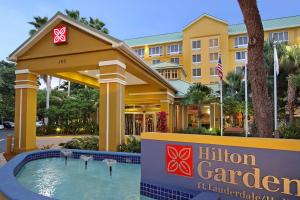 a hotel with a swimming pool in front of a building at Hilton Garden Inn Ft. Lauderdale Airport-Cruise Port in Dania Beach