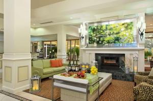 a living room with a fireplace and a tv at Hilton Garden Inn Ft. Lauderdale Airport-Cruise Port in Dania Beach
