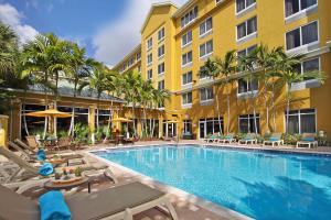a swimming pool in front of a building at Hilton Garden Inn Ft. Lauderdale Airport-Cruise Port in Dania Beach