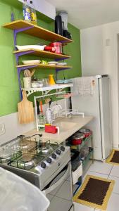 a kitchen with a sink and a stove at Apartamento Compacto Mobiliado in Natal