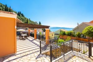 a house with a deck with a table and chairs at Villa Konstantinos in Katávolos