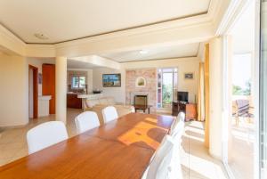a dining room and living room with a table and chairs at Villa Asimenia in Agia Triada