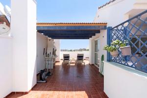 a balcony with a view of the ocean from a house at Townhouse with 3 bedrooms and sea views from the roof terrace in Torremolinos