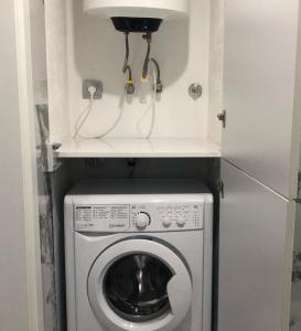 a washer and dryer in a small room at Black Sea Vi Dari Apartments in Batumi