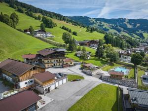 an aerial view of a small village with houses and a lake at Eibinghof BED & BREAKFAST in Saalbach-Hinterglemm