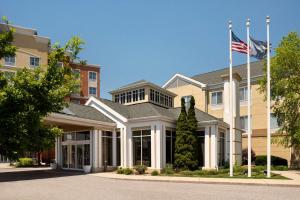 a building with an american flag in front of it at Hilton Garden Inn Fort Wayne in Fort Wayne