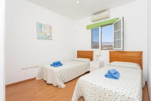 a bedroom with two beds and a window at Villa Tania in Puerto del Carmen +32 photos