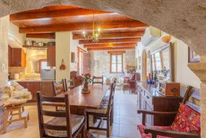 a kitchen and dining room with a table and chairs at Archontiko Galliaki in Áyios Yeóryios