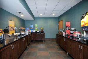 a coffee shop with wooden counters in a room at Hampton Inn Grand Rapids-South in Wyoming