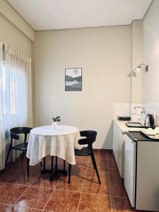 a kitchen with a table and chairs and a table and a table and a kitchen at Hotel Renacer Tarija in Tarija