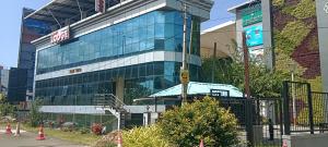 a large glass building with a sign on it at Rosh Tower in Trivandrum