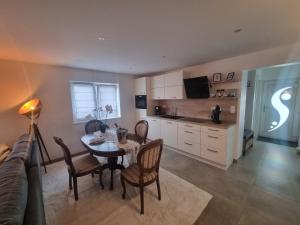 a kitchen and dining room with a table and chairs at Wellness Ferienhaus in Mechernich