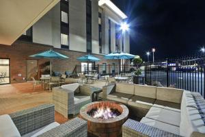 a patio with couches and a fire pit at night at Hampton Inn & Suites Grants Pass in Grants Pass